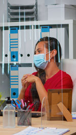 Side view of young woman working in laboratory