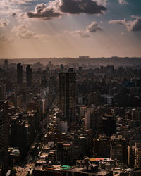 High angle view of city buildings against sky during sunset