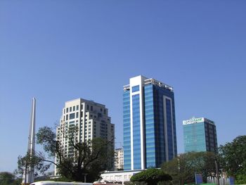 Low angle view of skyscrapers against clear sky