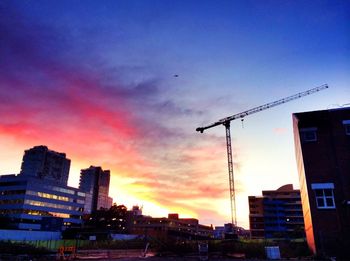 Buildings in city at sunset