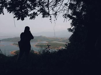 Silhouette of man on landscape against sky