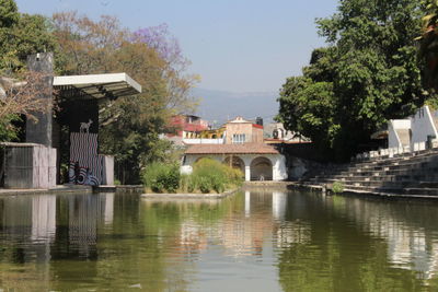 Arch bridge over river against sky