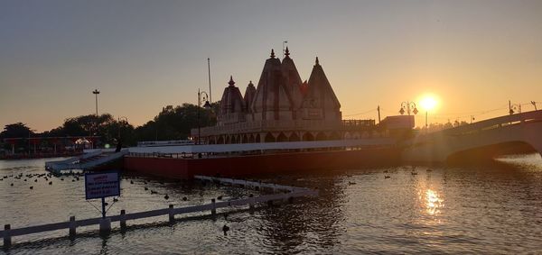 View of boats in river at sunset