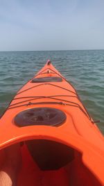 Boat floating on sea against clear sky