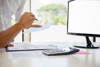 Close-up of business colleagues working in office