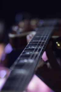 Close-up of hands playing guitar