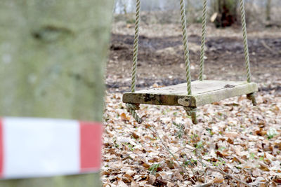 Close-up of swing hanging on rope against wall