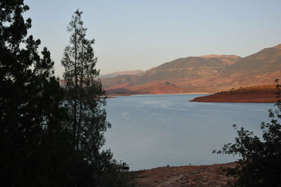 Scenic view of lake and mountains against clear sky