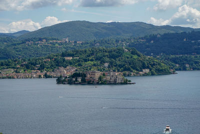 Scenic view of sea and townscape against sky