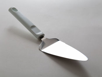 High angle view of cigarette on table against white background