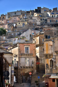 Buildings in city against clear sky