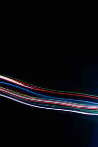 Light trails against black background