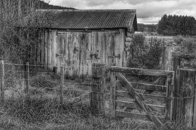 Old wooden house on field