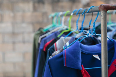 Close-up of multi colored clothes hanging on rack at store