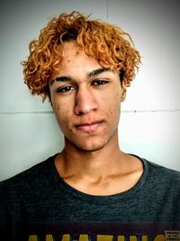 Portrait of young man against wall