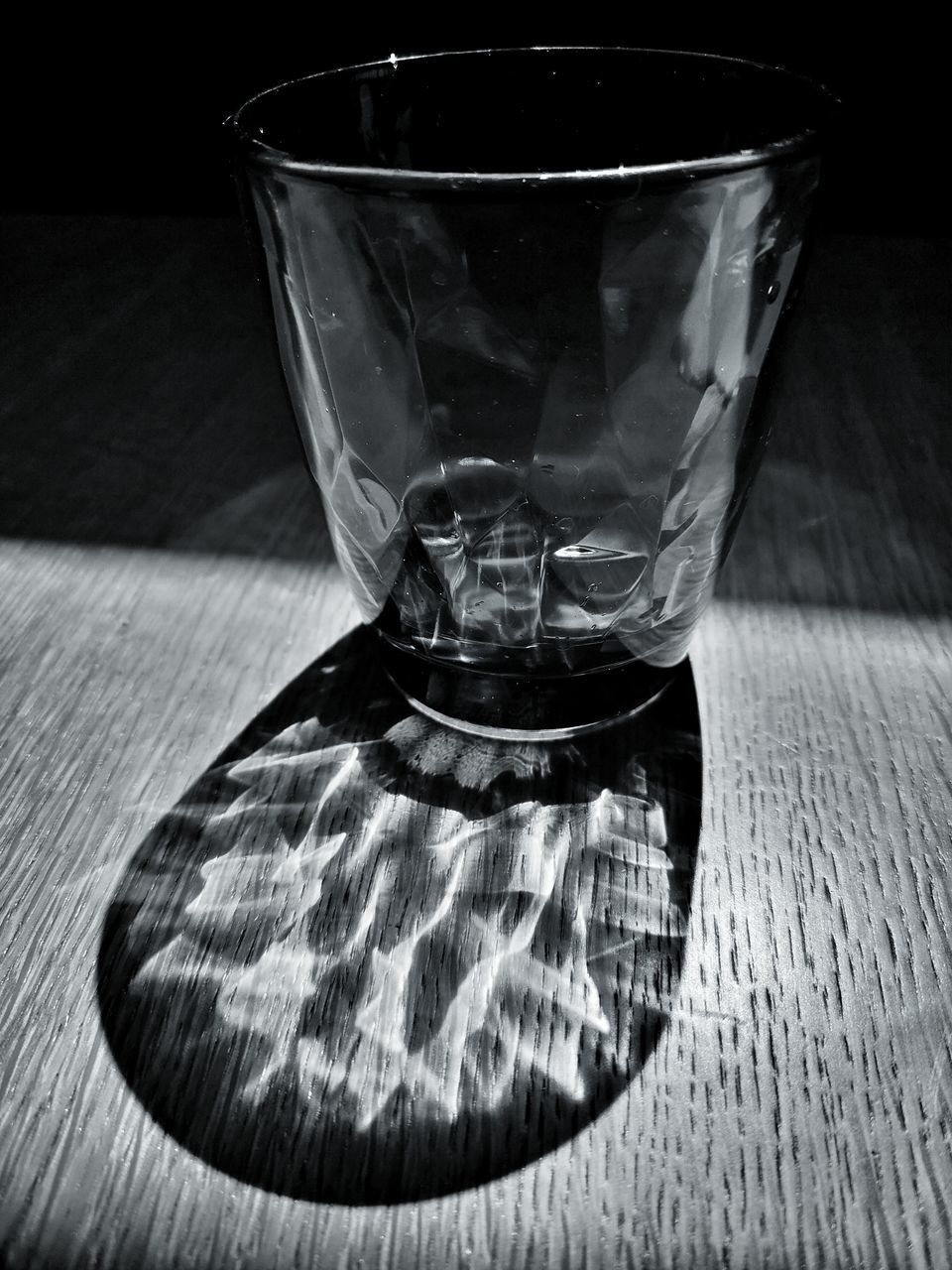 CLOSE-UP OF EMPTY GLASS ON TABLE