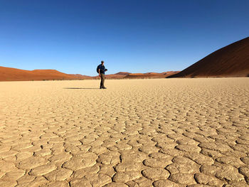 Full length of man on desert against clear sky
