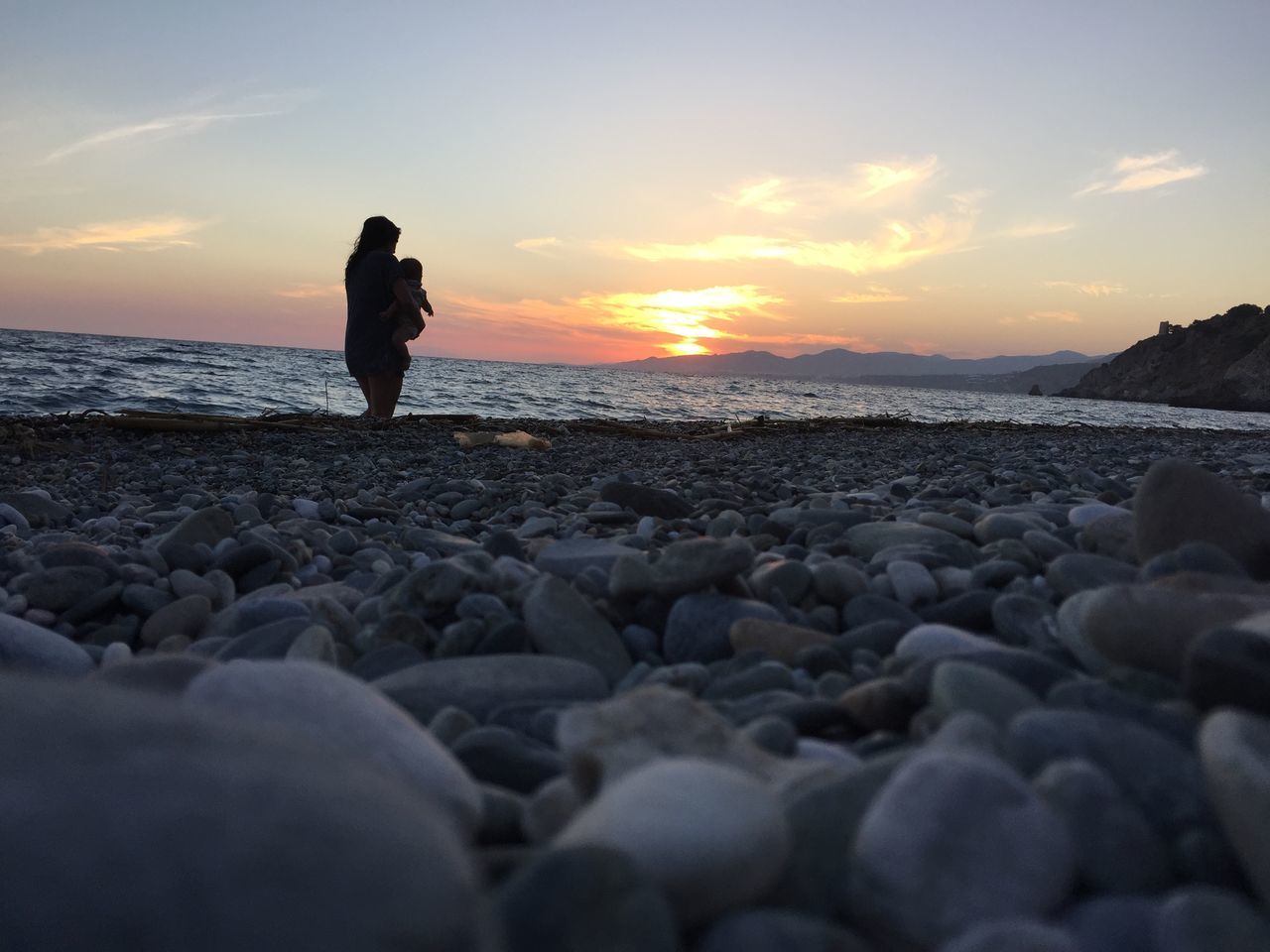 sea, sunset, beach, water, horizon over water, sky, scenics, shore, tranquil scene, rock - object, tranquility, beauty in nature, standing, lifestyles, nature, leisure activity, silhouette, idyllic