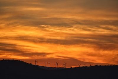 Scenic view of silhouette landscape against romantic sky at sunset