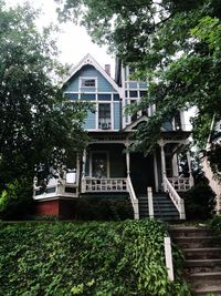 Low angle view of house and trees against sky