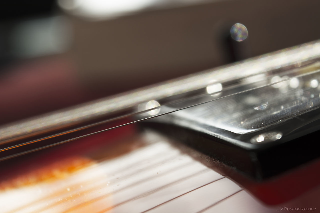 CLOSE-UP OF GUITAR ON PIANO