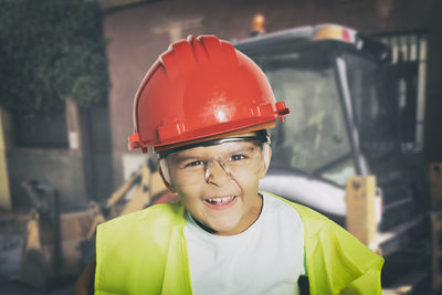 Portrait of smiling man standing at construction site