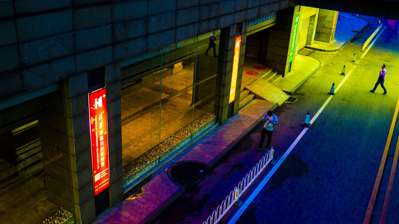 HIGH ANGLE VIEW OF ILLUMINATED BUILDINGS IN CITY