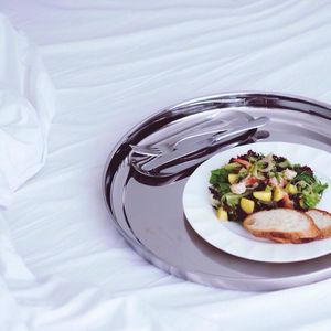 High angle view of salad in plate on bed