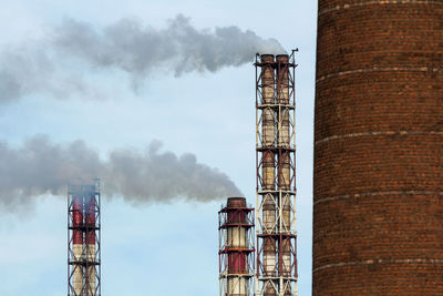 Low angle view of smoke stack against sky