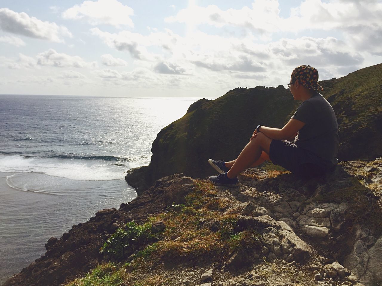 water, sea, lifestyles, leisure activity, horizon over water, sky, sitting, men, rear view, scenics, tranquil scene, tranquility, full length, standing, cloud - sky, person, nature, beauty in nature