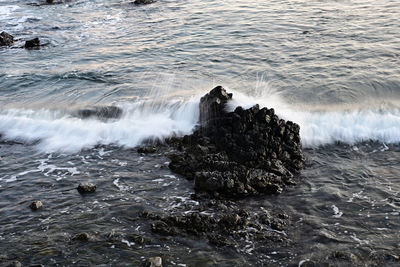 Scenic view of sea waves splashing on rocks