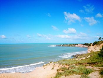 Scenic view of beach against blue sky