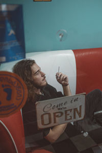 Portrait of young man smoking cigarette