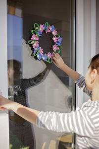 Side view of young woman holding bouquet