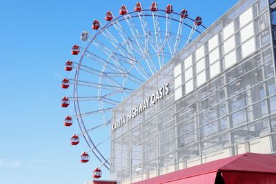 Low angle view of ferris wheel against sky