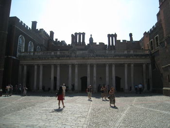 People at historical building in city