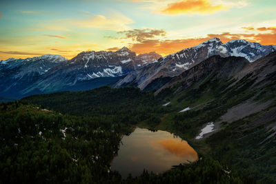 Scenic view of snowcapped mountains against sky during sunset