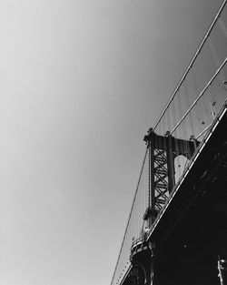 Low angle view of suspension bridge against sky