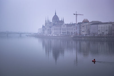 The parliament building of hungary at a foggy morning.