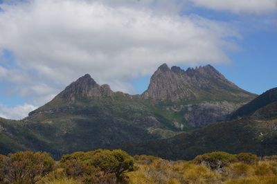 Scenic view of mountains against cloudy sky