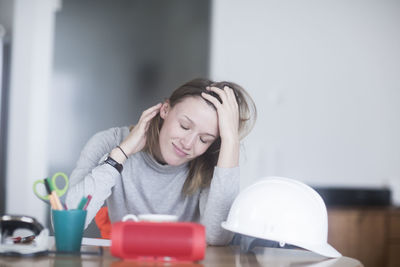 Young woman with long hair learning at home