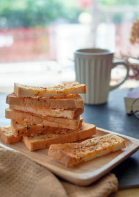 Garlic breadsticks in a wooden tray