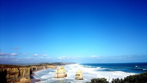 Scenic view of sea against clear blue sky