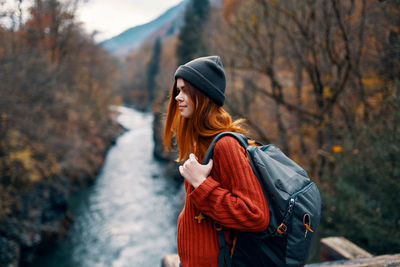 Woman standing in forest during winter