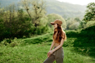 Rear view of woman standing on field