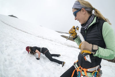 One female mountaineer teaches the other how to self-arrest on mt. baker