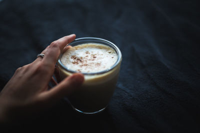 Cropped image of hand holding coffee cup