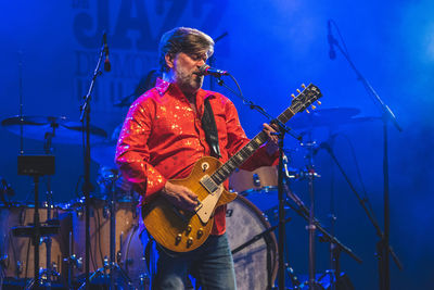 Full length of man playing guitar