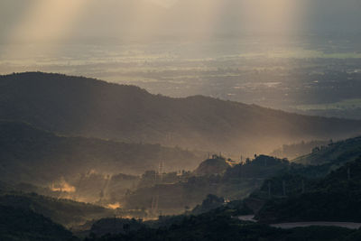 Scenic view of mountains against sky at sunset