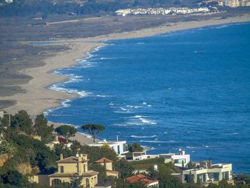 High angle view of sea and buildings in city